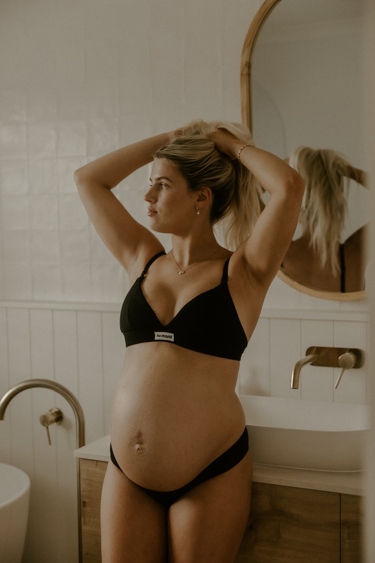 Leakproof maternity bralette in black worn by pregnant women