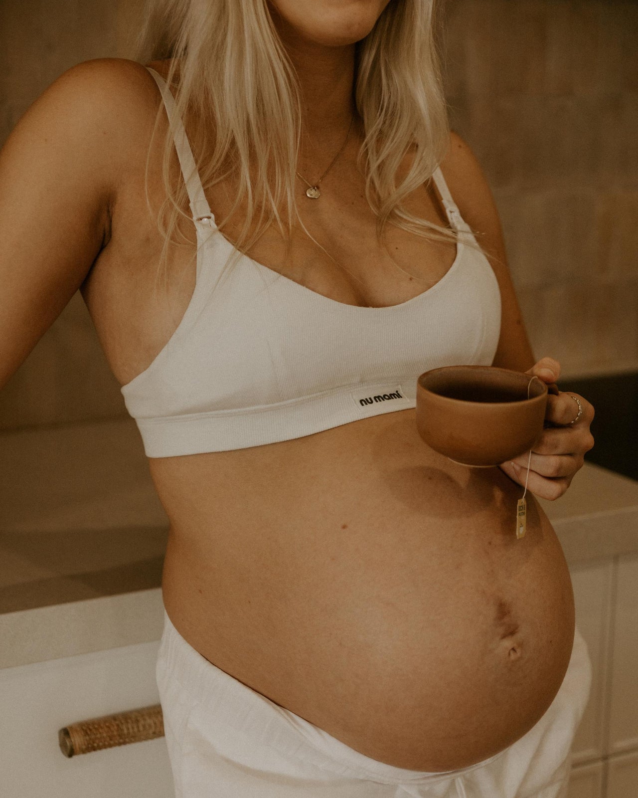 Leakproof maternity bra in white worn by pregnant women